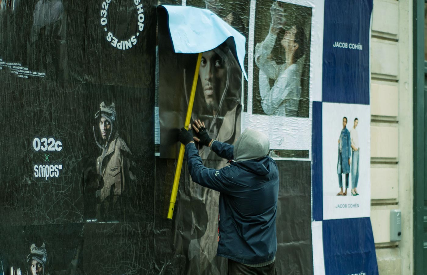 Wheatpaste poster installation by street teams in Vancouver